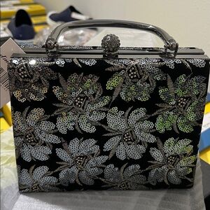 D’margeaux Elegant Black and Silver Mini Bag with long chain for shoulder wear.